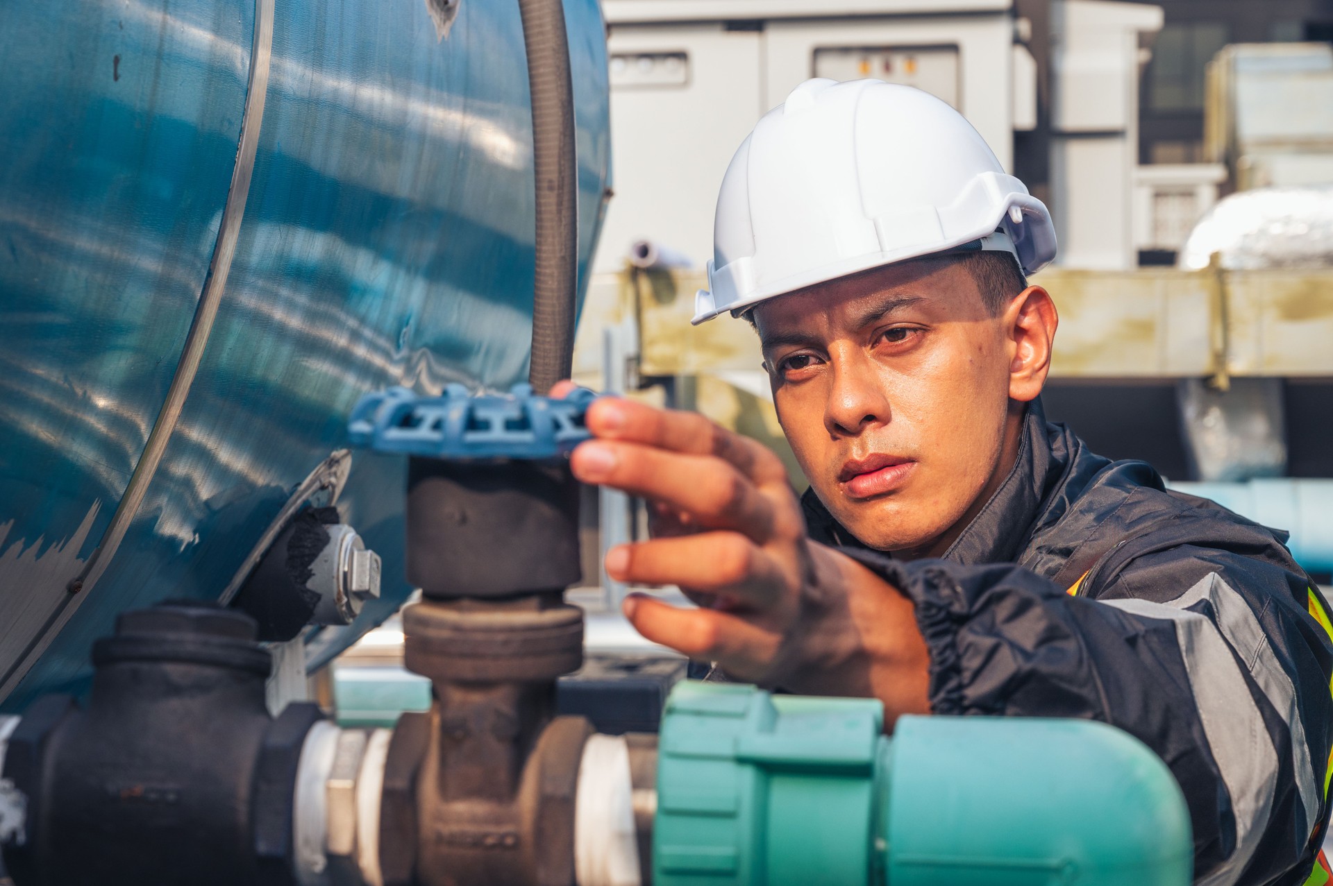The image captures a skilled engineer inspecting a network of pipelines in a petrochemical facility. the concept of projects related to petrochemicals, engineering, and industrial inspection.